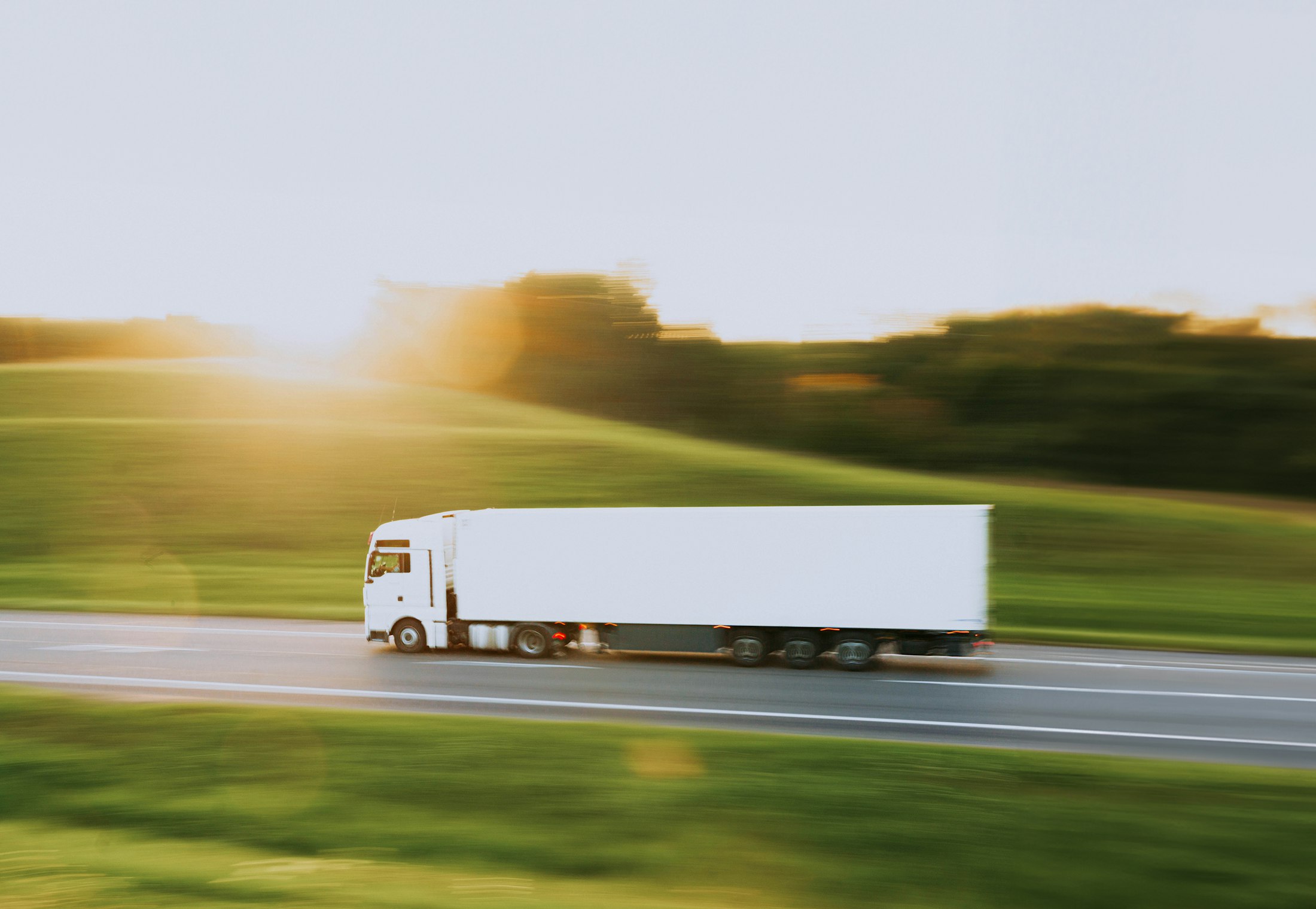Semi truck moving fast along a rural highway