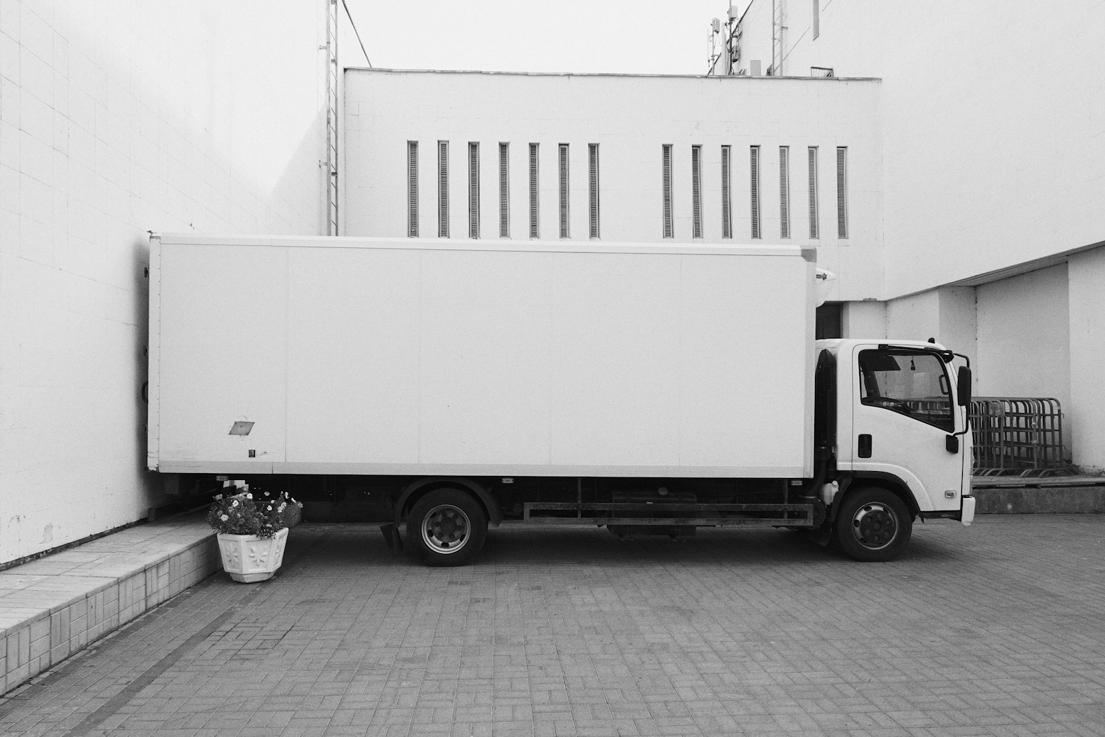 White box truck parked at a building