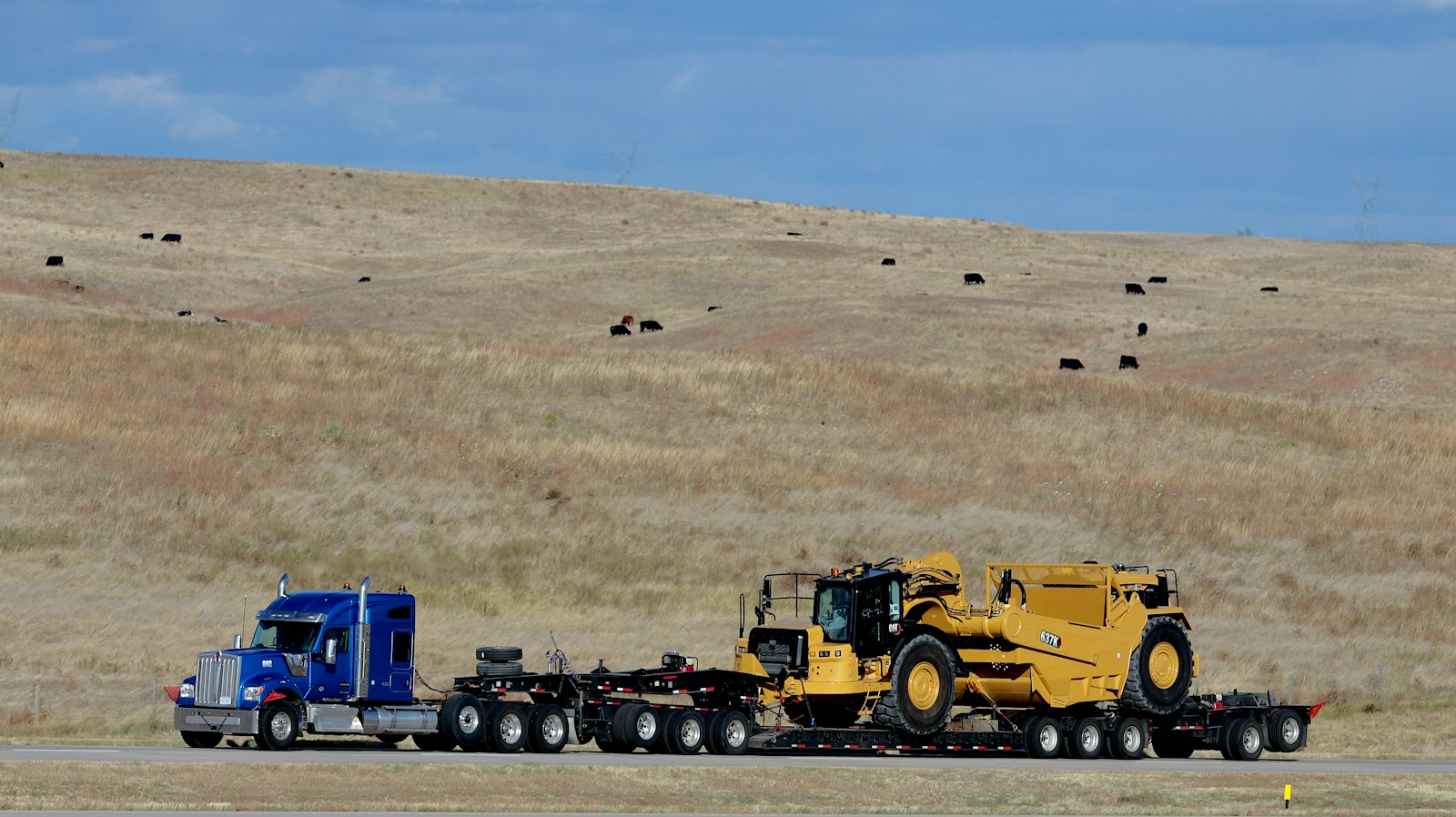 Heavy equipment loaded on a low-deck trailer