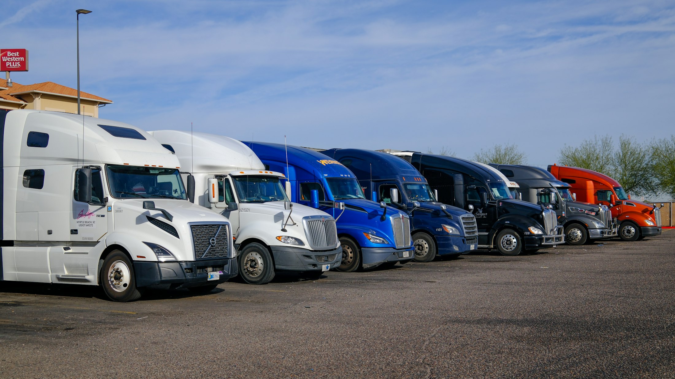 Row of semi trucks parked side by side